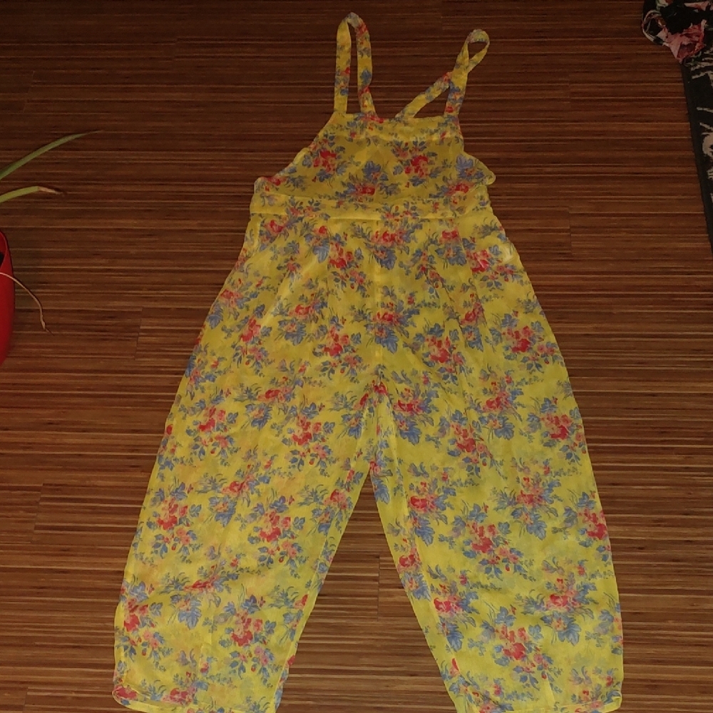 Kimchi Blue Yellow Floral Jumpsuit with Thin Straps. Material is Sheer.